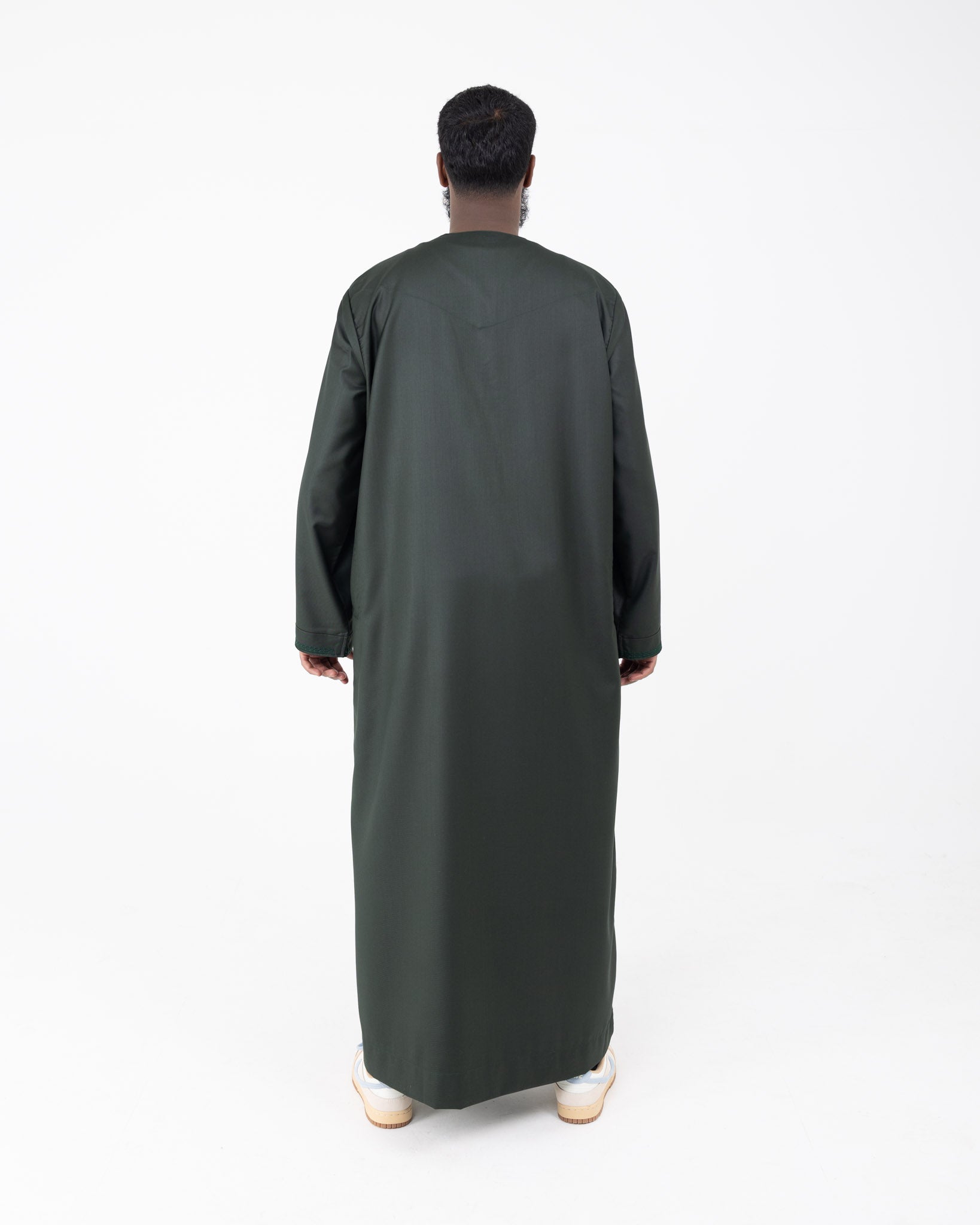 Back of embroidered Rayan green thobe with embroidery on the neckline and cuffs.